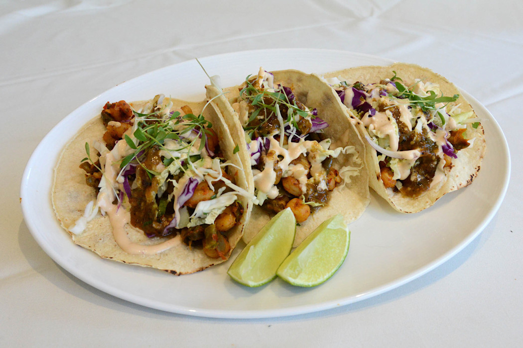 A plate of three tacos. 