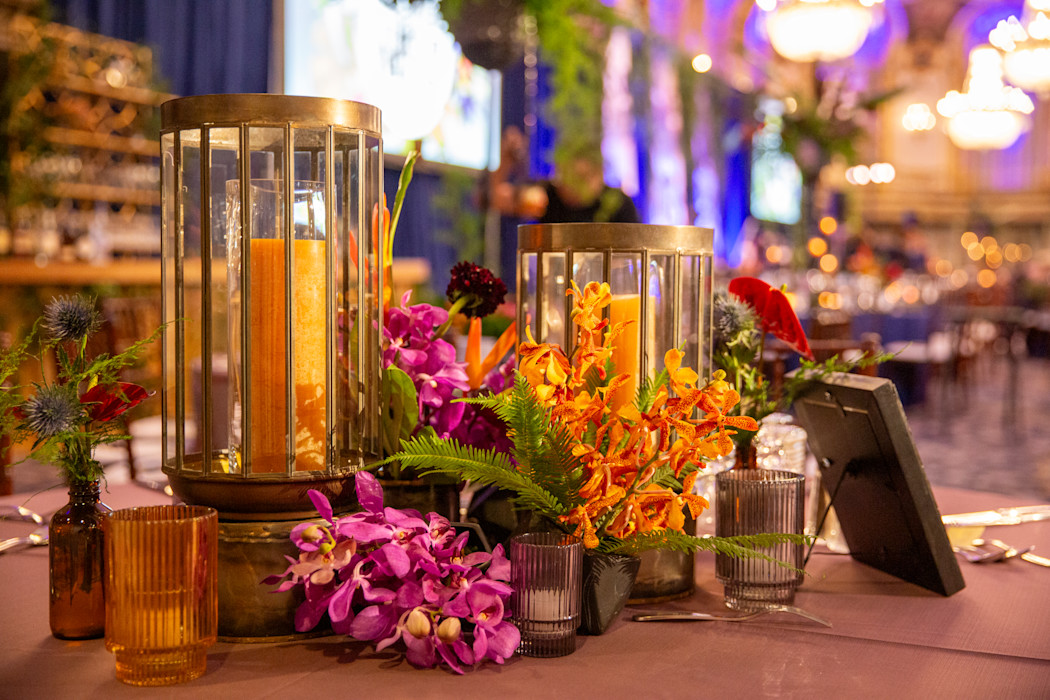 A table is set with flowers and candles. 