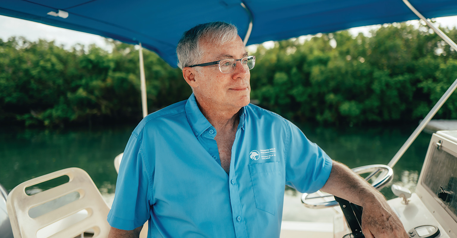 Dr. Randall Wells stands on a boat.
