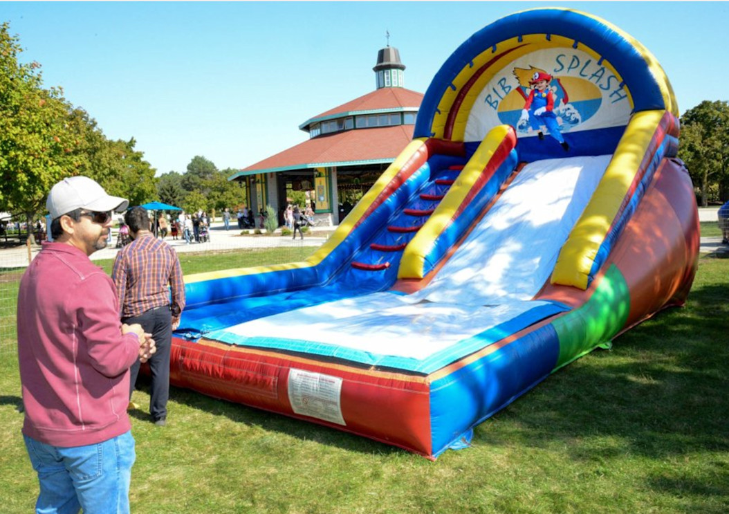 An inflatable slide sits on the grass. 