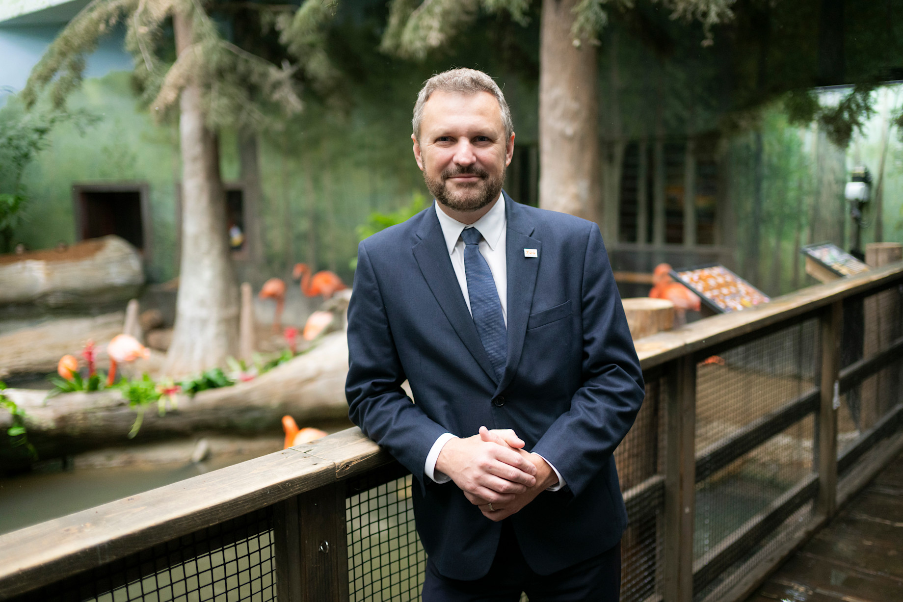 Dr. Mike Adkesson stands against a bridge in the Swamp habitat. 