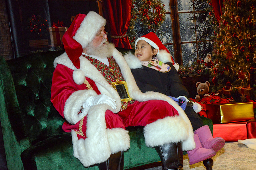 A child sits on Santa's lap at Holiday Magic. 