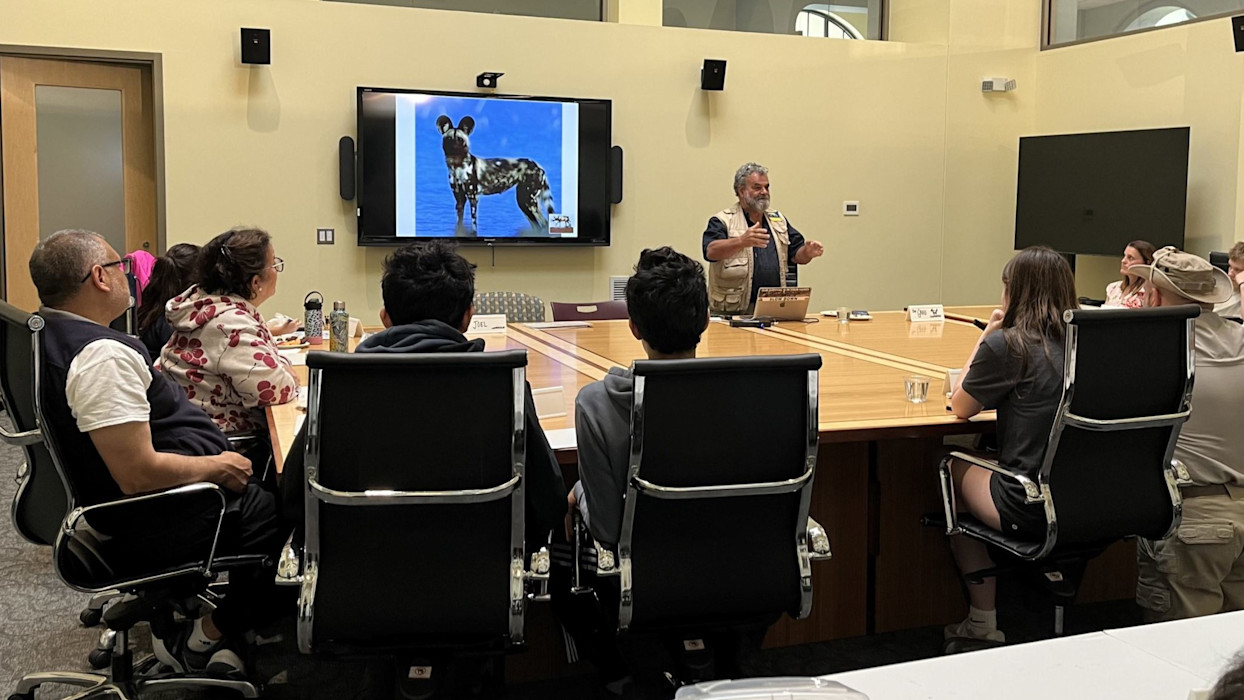 A conservationists gives a presentation to a boardroom of people. 